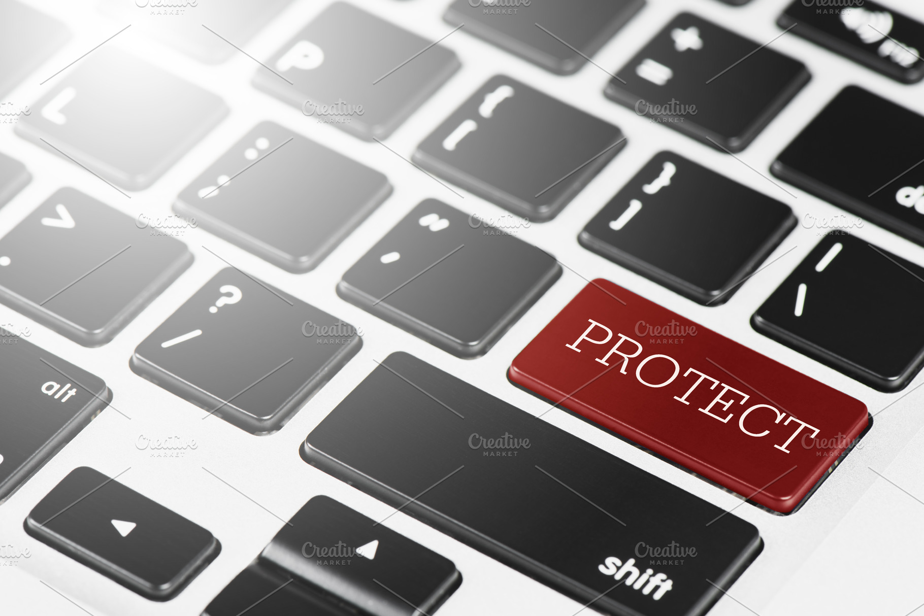 PROTECT Red button keyboard on laptop computer for Business an, a Technology Photo by Ministocker