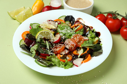 Concept of tasty food with vegetable salad with tahini sauce on, a Background Photo by AtlasStudio PRO