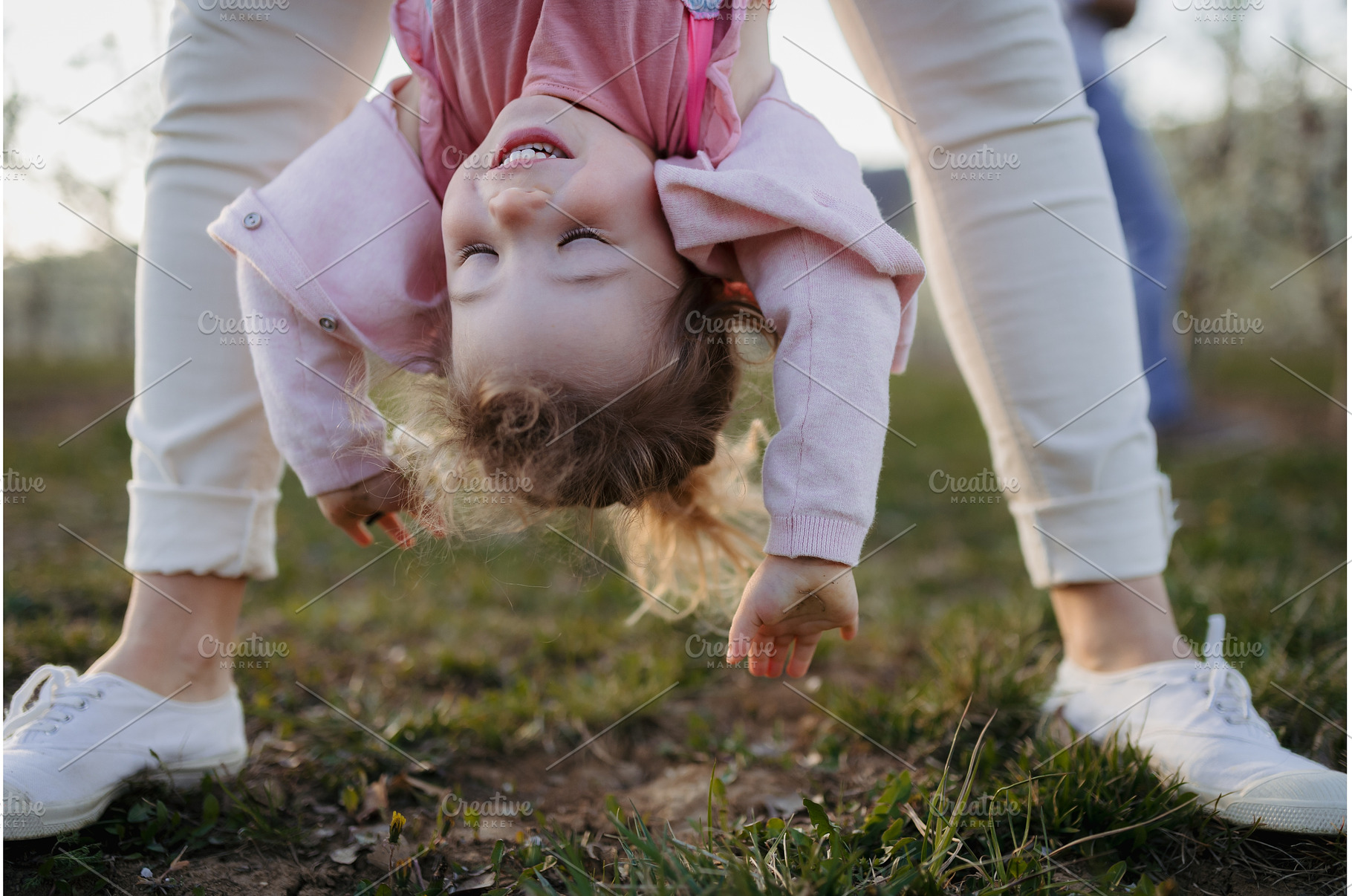 Parent lifting children upside down, a Nature Photo by HalfPoint