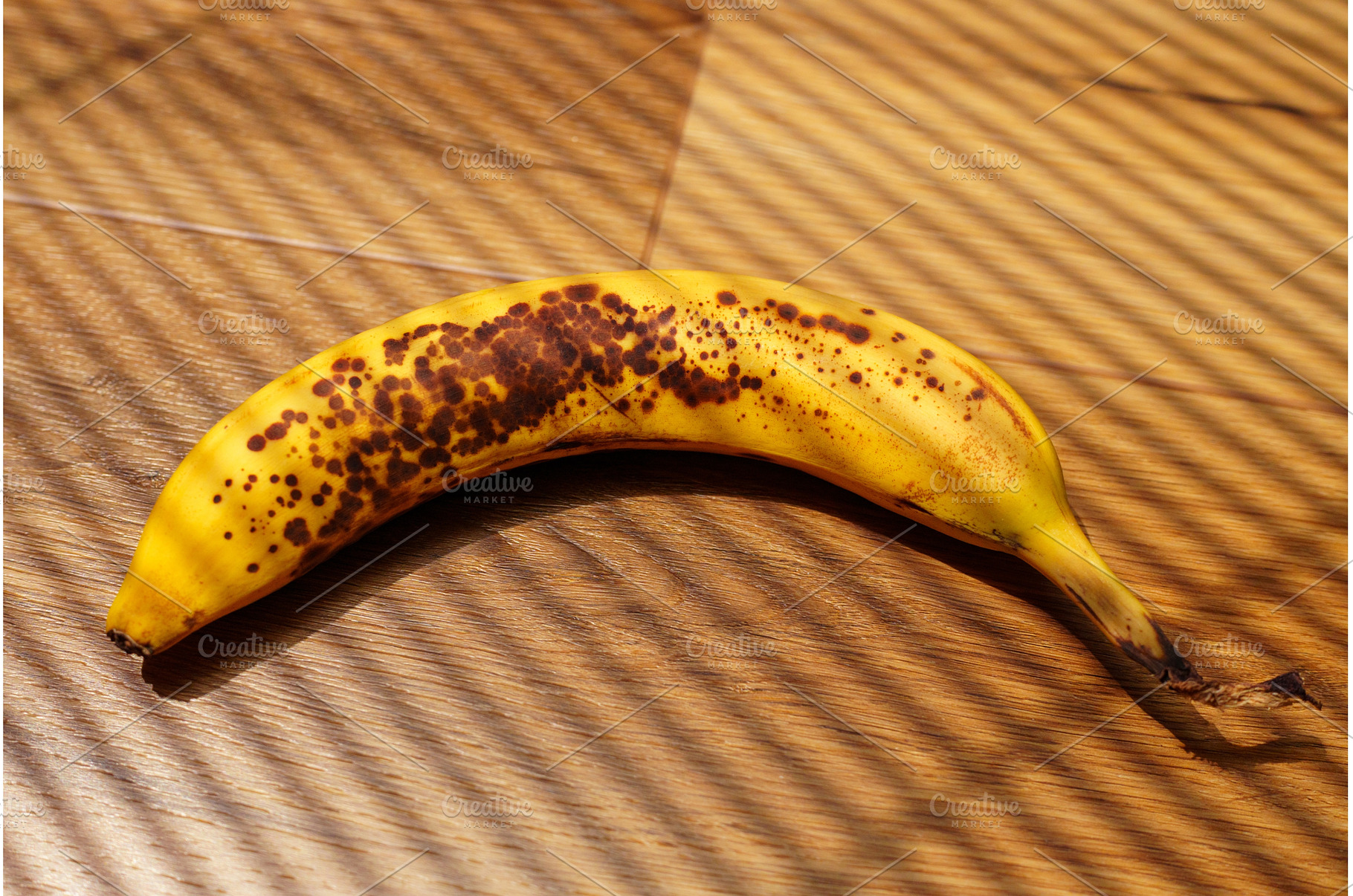 A bright yellow banana with brown, a Food & Drink Photo by darksoul72