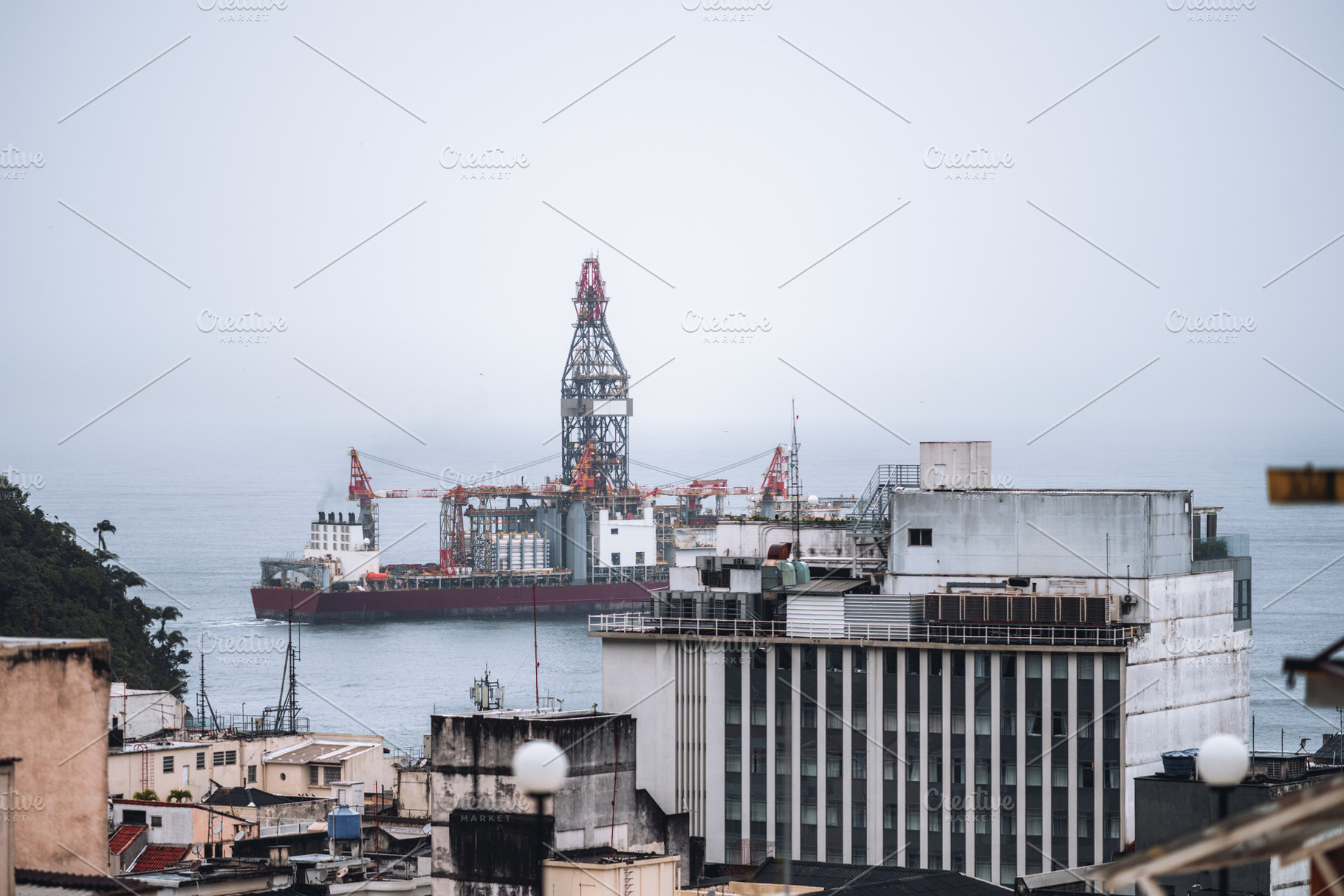 Offshore rig near city buildings, an Industrial Photo by SkyNext