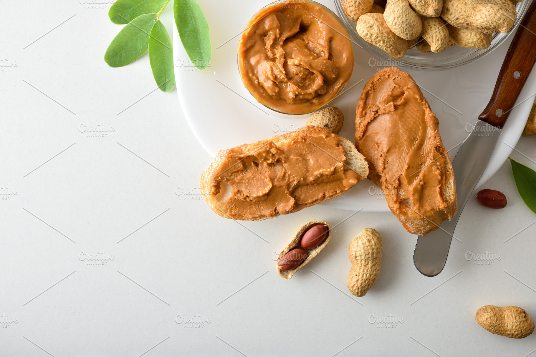 Bread with peanut butter isolated on white table, a Food & Drink Photo by Davizro's Market