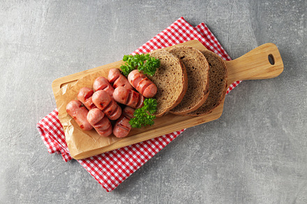 Concept of tasty food, grilled mini sausage, top view, a Background Photo by AtlasStudio