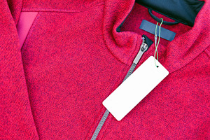 Clothing label tag on a red jacket, a Business Photo by BOOCYS
