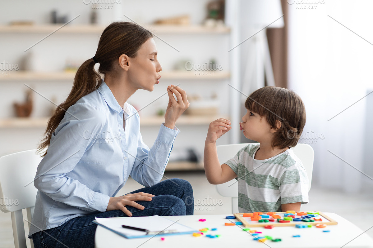 Young woman speech therapist studying together with small kid, learning practic, a Photo by Prostock-Studio (Photo 2 of 2)