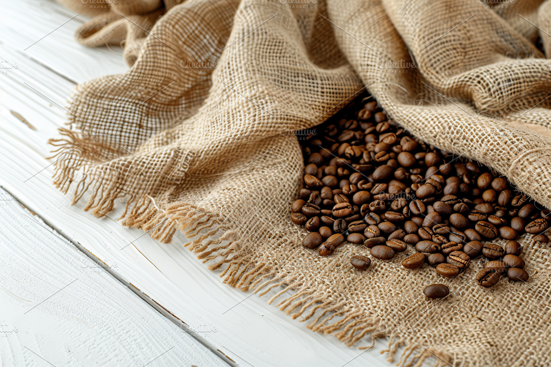 Sackcloth with heap of coffee beans on wooden table, a Food & Drink Photo by AlyaAnd