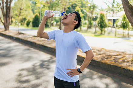 Young Asian man drinking water after, a Person Photo by Sewupari Studio