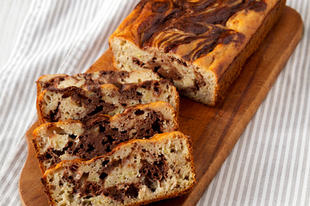 Homemade Chocolate Banana Bread on a rustic wooden board on a wh, a Food & Drink Photo by LiudmylaChuhunova