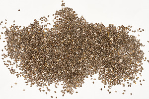 Scattered chia seeds on a white background, top view, a Food & Drink Photo by ndanko
