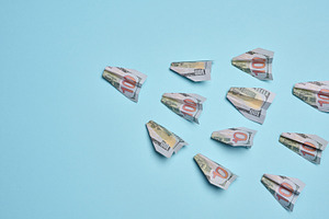 Paper airplanes made of hundred-dollar bills flying in one direc, a Business Photo by ndanko