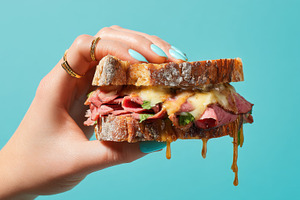 Hand with meat and cheese sandwich, a Photo by Beautiful things