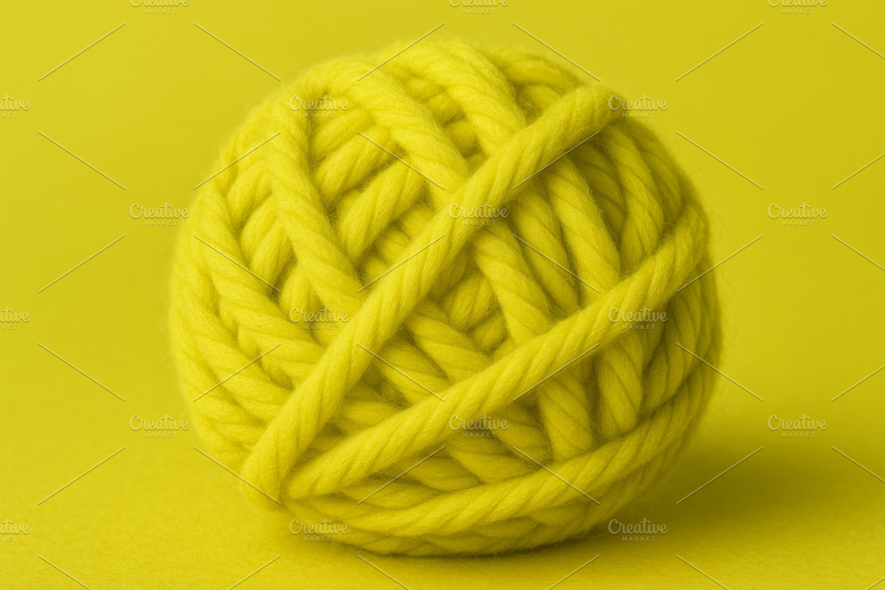 Ball of yellow yarn on matching char, a Photo by Dvoevnore photos
