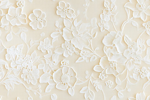 Seamless textured wall featuring intricate white floral designs, showcasing var, a Background Graphic by Textures & Backgrounds