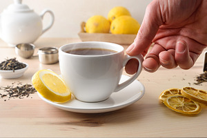 Person drinking black tea on table with ingredients, a Food & Drink Photo by Davizro's Market