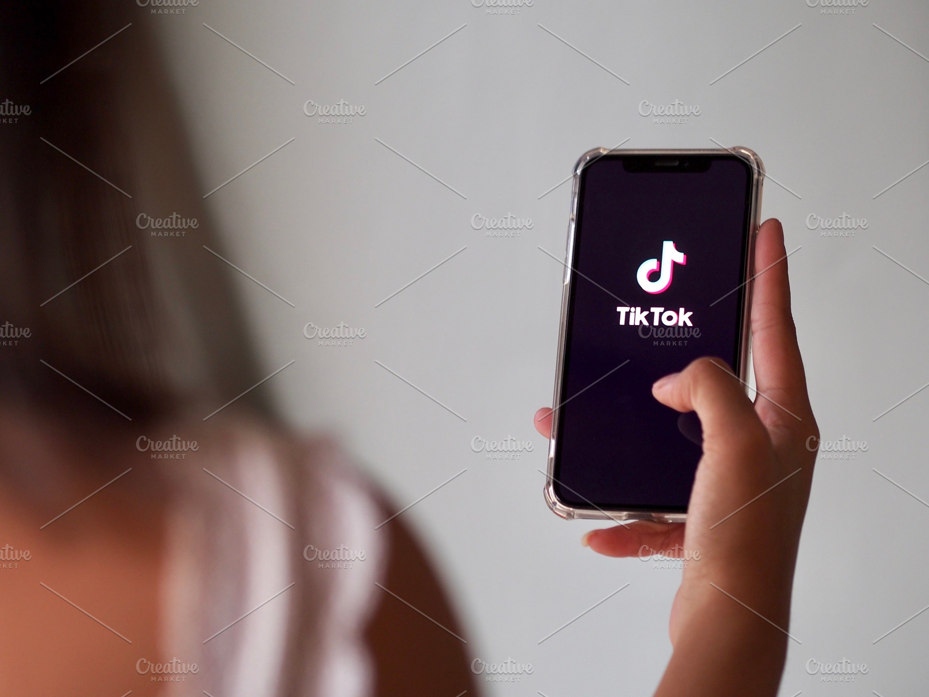 A woman using TikTok app, a Person Photo by PEMIKA