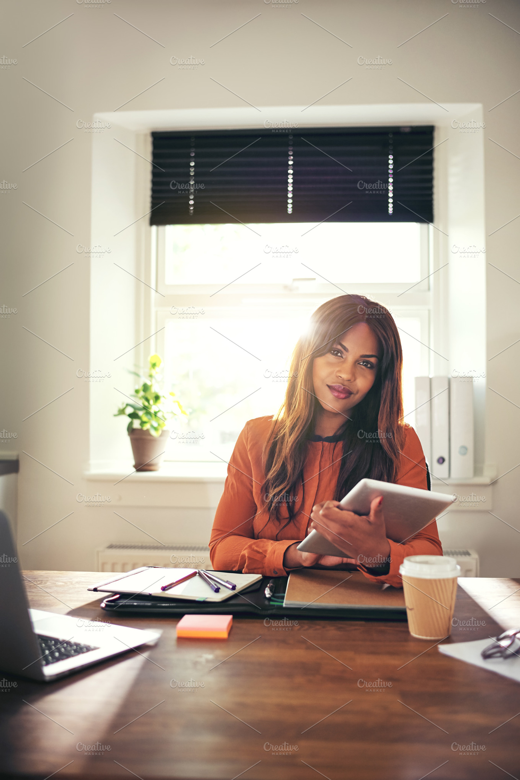 Confident young woman using a tablet in her home office featuring adult, a Business Photo by Stefan & Janni