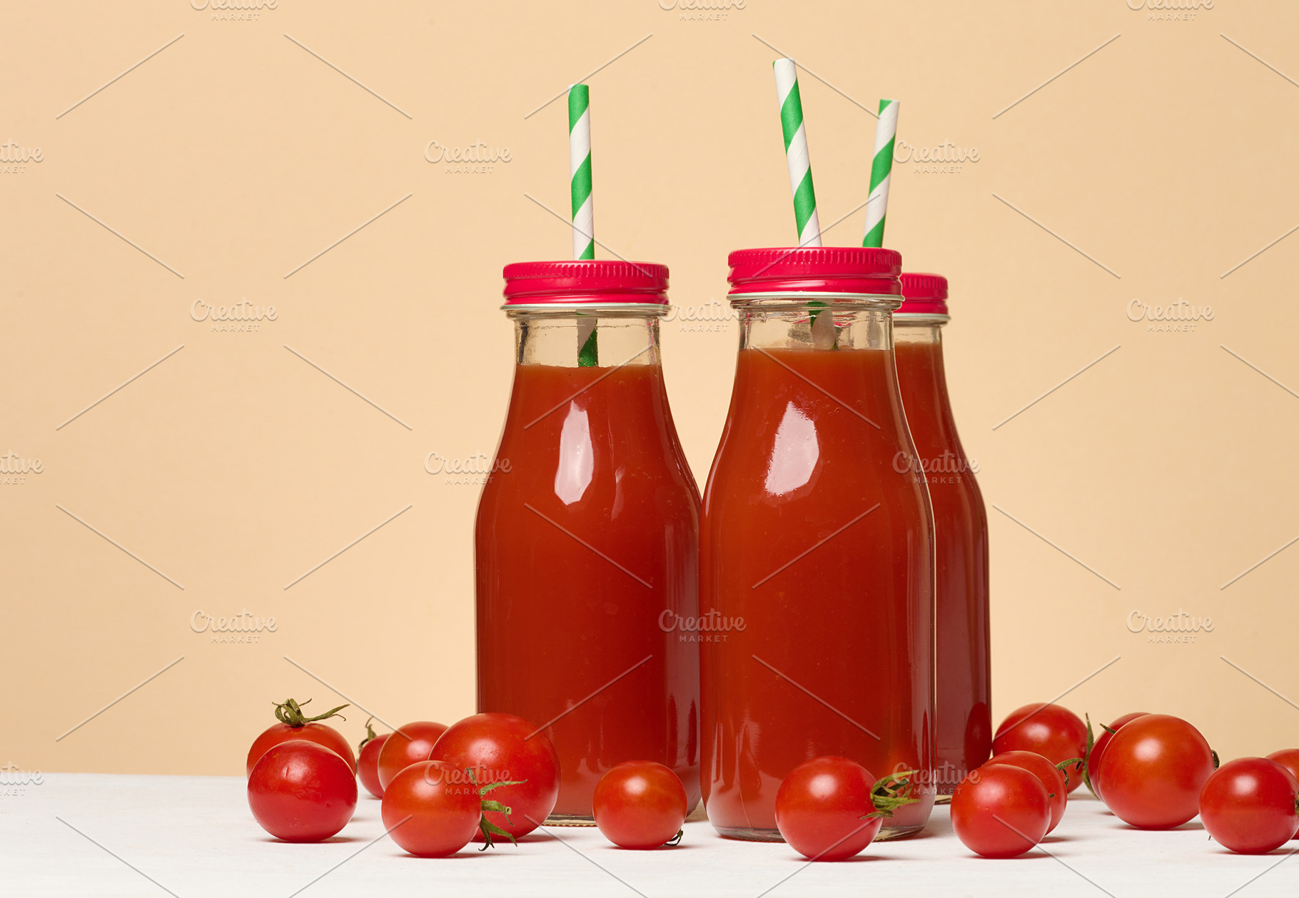 Tomato juice in a glass bottle and fresh cherry tomatoes on the, a Food & Drink Photo by ndanko