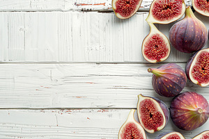 Fresh figs with copyspace on wooden table, a Food & Drink Photo by AlyaAnd