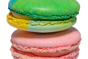 Pink and green macarons on isolated background, close up, a Food & Drink Photo by ndanko