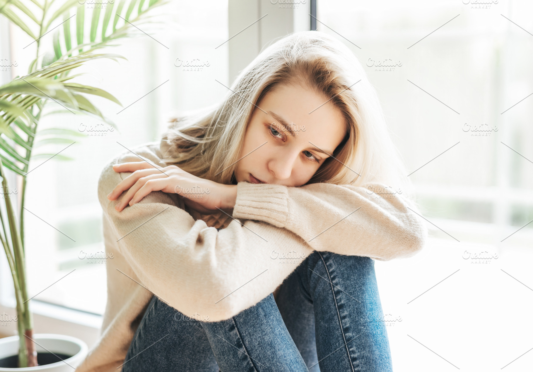 Sad girl near window thinking about something, a Person Photo by Olena Rudo
