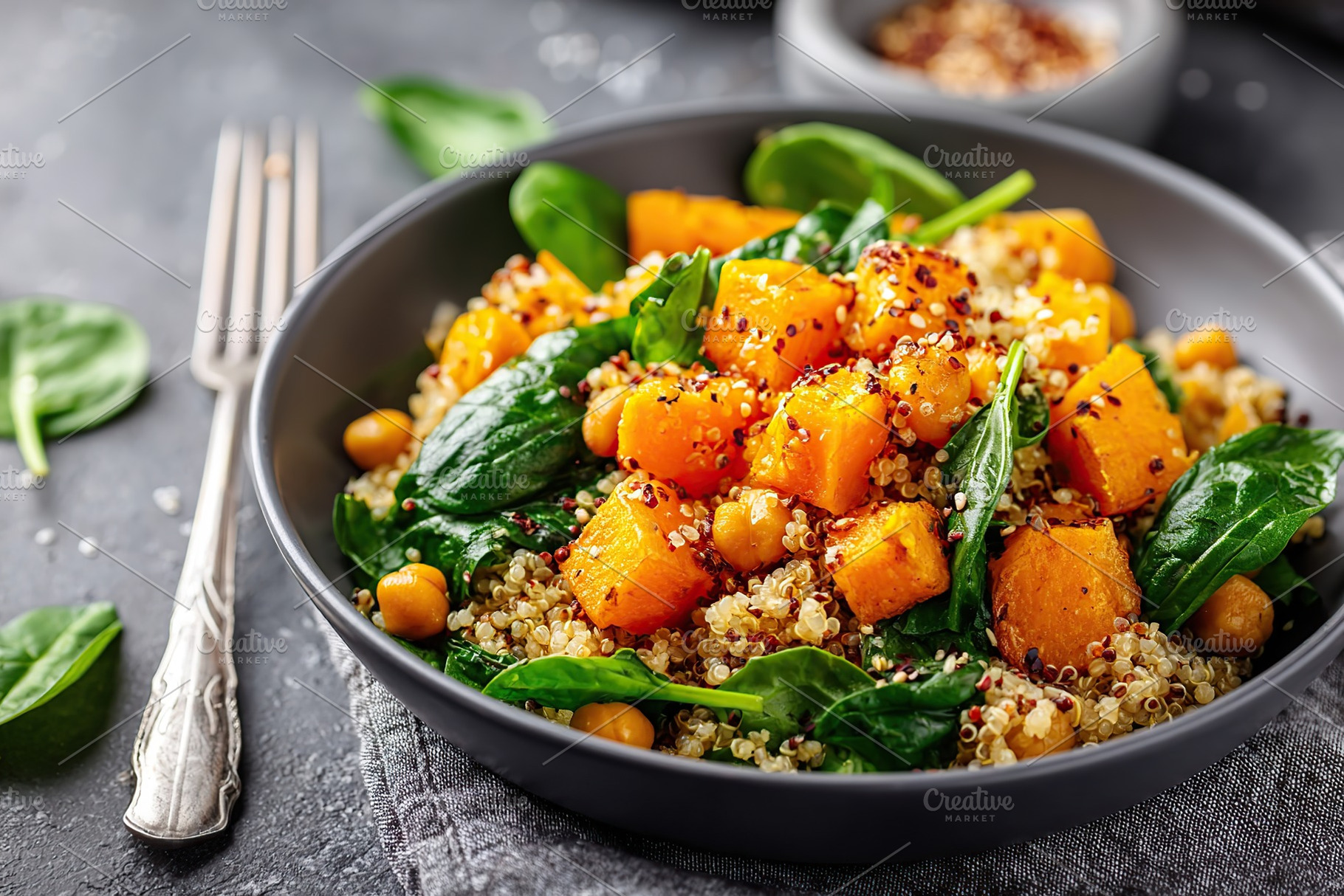 Colorful quinoa bowl with spinach and roasted squash in a modern kitchen settin, a Photo by AlyaAnd