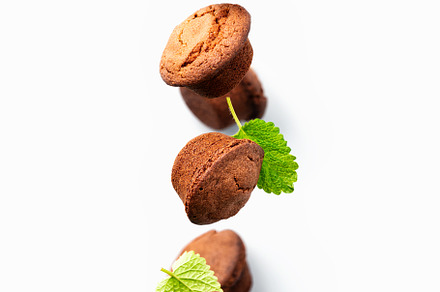 Chocolate muffins with mint leaves levitation, light gray background, a Food & Drink Photo by Natalia Klenova's Shop