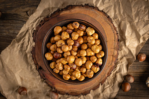 Shelled hazelnuts filling a bowl, a Photo by Grafvision photography