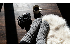 Cozy scene with gray knitted socks, a Background Photo by tilialucida