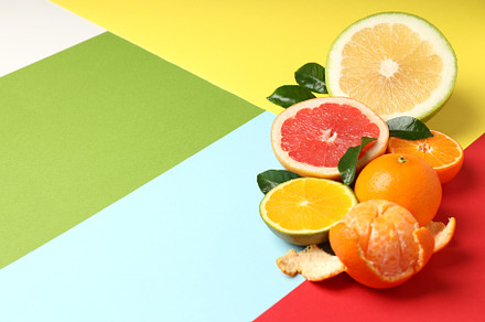 Citrus fruits with leaves on multicolored background, a Food & Drink Photo by AtlasStudio PRO