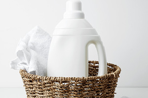 Laundry detergent branding mock up and basket filled with clean white towels. H, a Photo by matucha