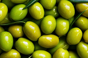 Fresh green olives background with leaves, showing healthy Medit, a Photo by Studio ANNA
