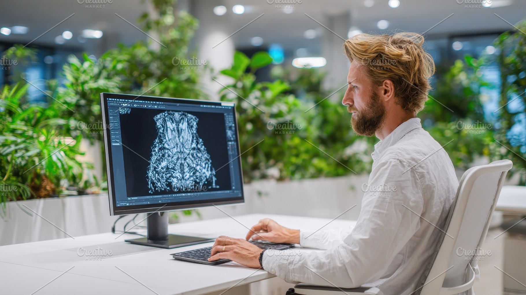 Man working on 3D design software in, a Photo by Pixeness Studio