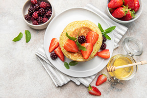 Pancakes with fresh strawberries blackberries honey mint, a Food & Drink Photo by Olena Rudo
