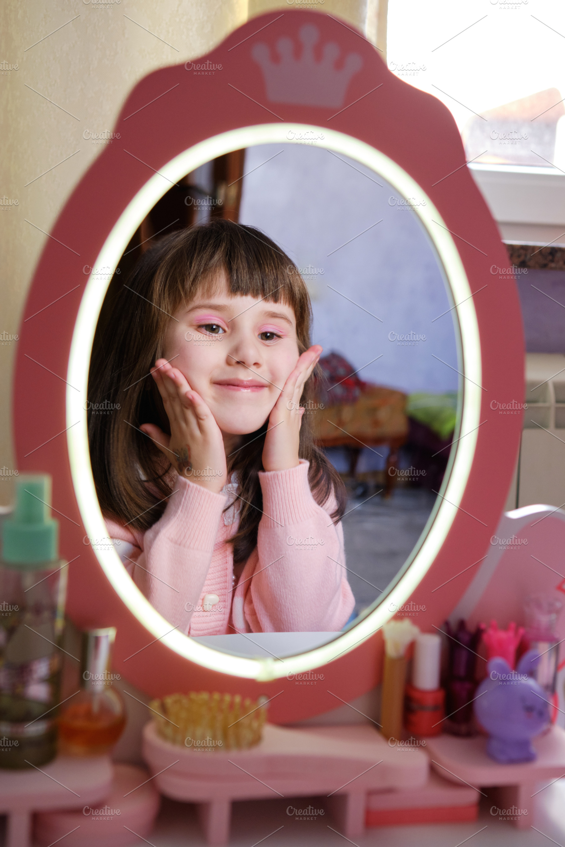 Happy little girl admiring her makeup in a toy mirror and smiling., a Person Photo by Rohan Photography