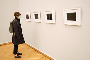 Woman with face mask in art gallery, a Health & Medical Photo by BOOCYS