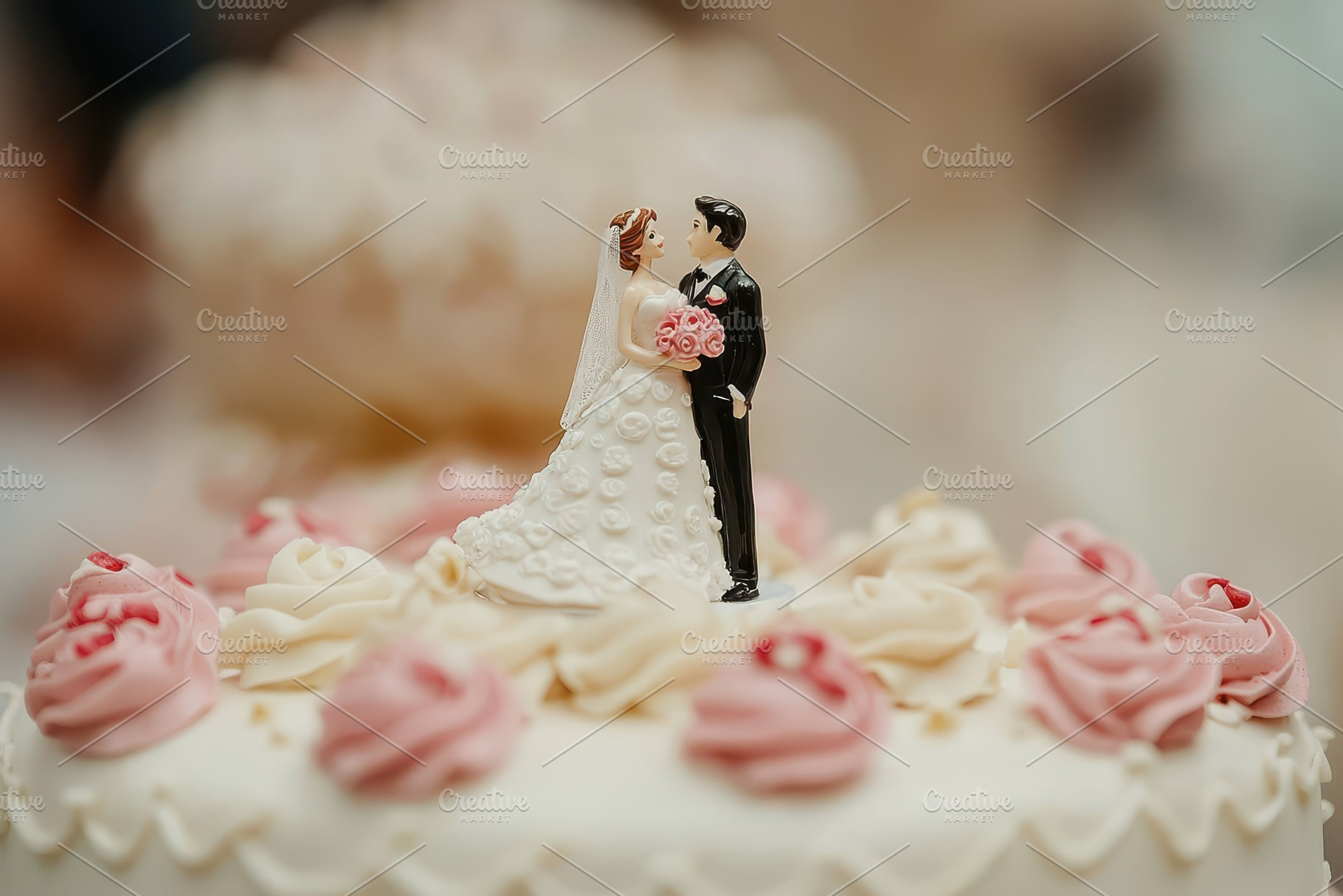 Bride and groom figurines adorn, a Photo by Pavel_design