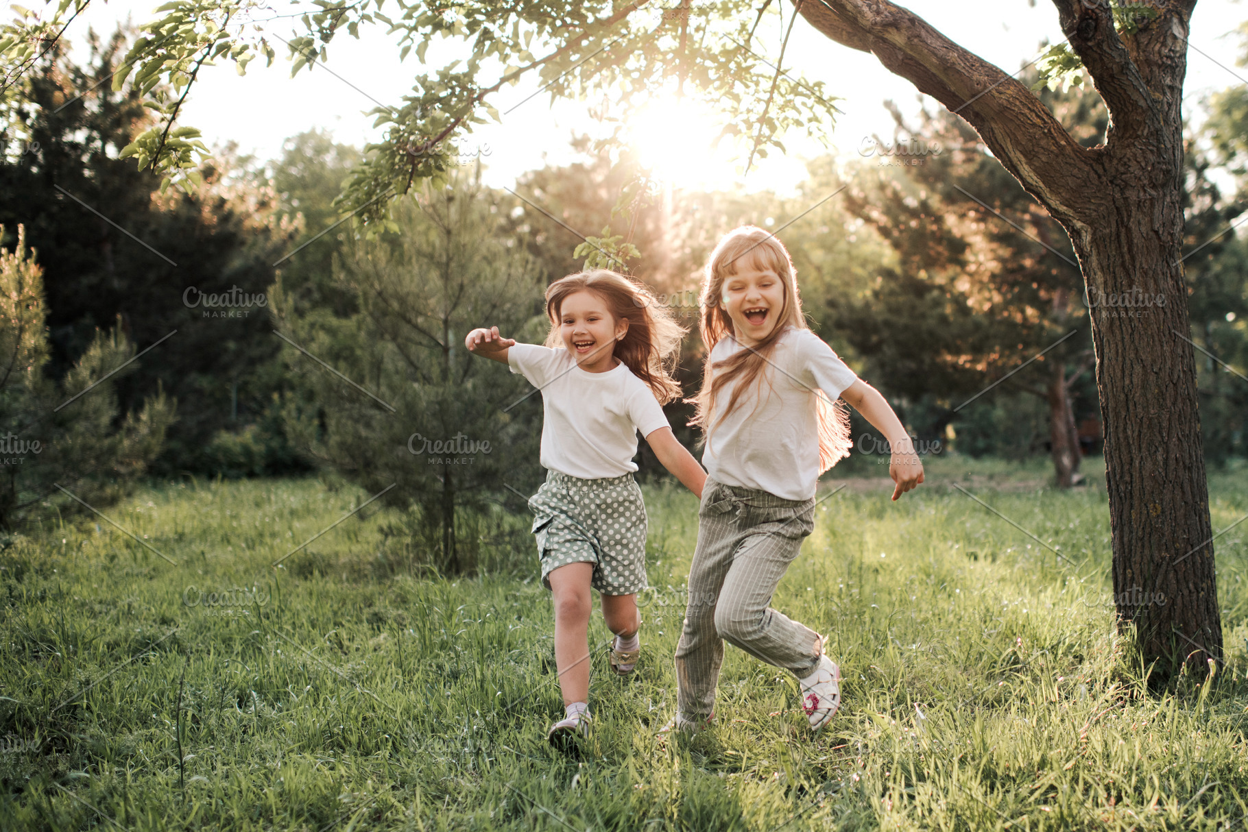 Cheerful kid girls in park, a Person Photo by morrowlight