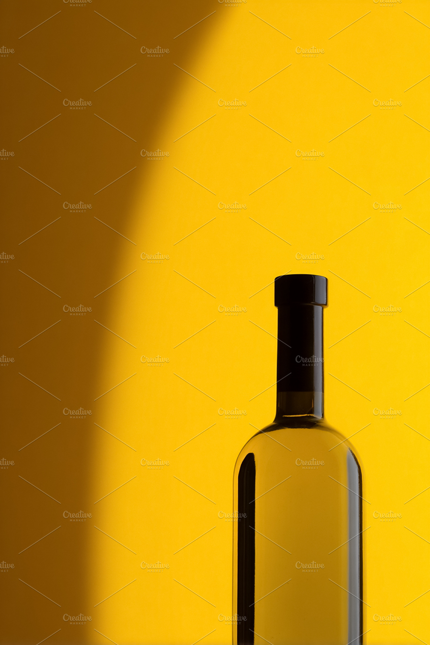 Clear glass bottle containing liquid with a black cap on a vibra, a Photo by Studio ANNA