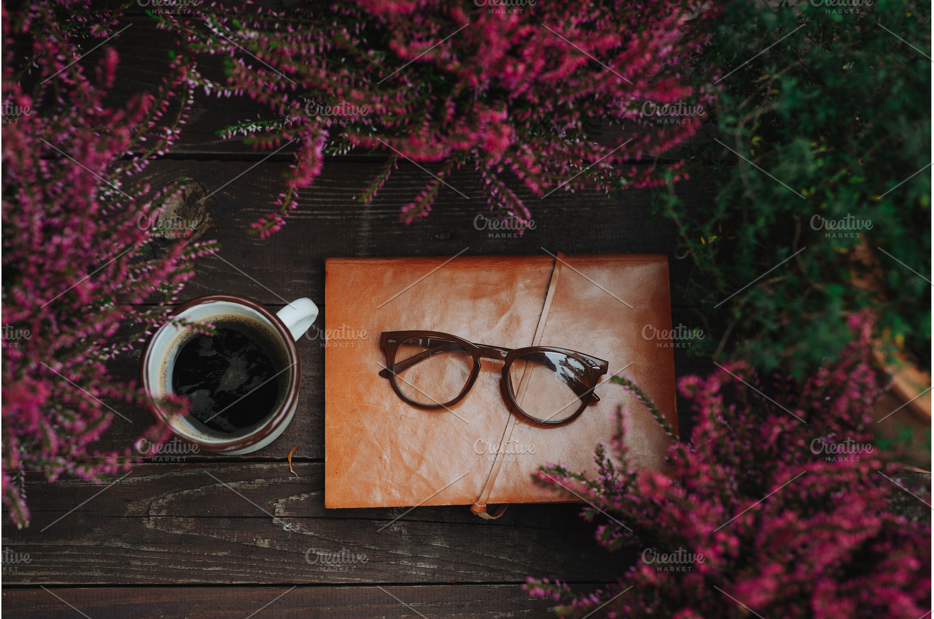 Reading glasses resting on notebook, a School & Education Photo by HalfPoint