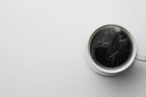 Top view of a steaming coffee cup on, a Photo by LOGOCREATIVE