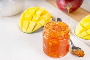 Golden mango marmalade jam with fresh mango fruits, a Photo by Rimma