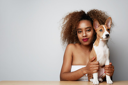 Young black african female with afro stock photo containing love and puppy