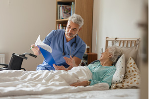 Caregiver doing regular check-up of, a Health & Medical Photo by HalfPoint
