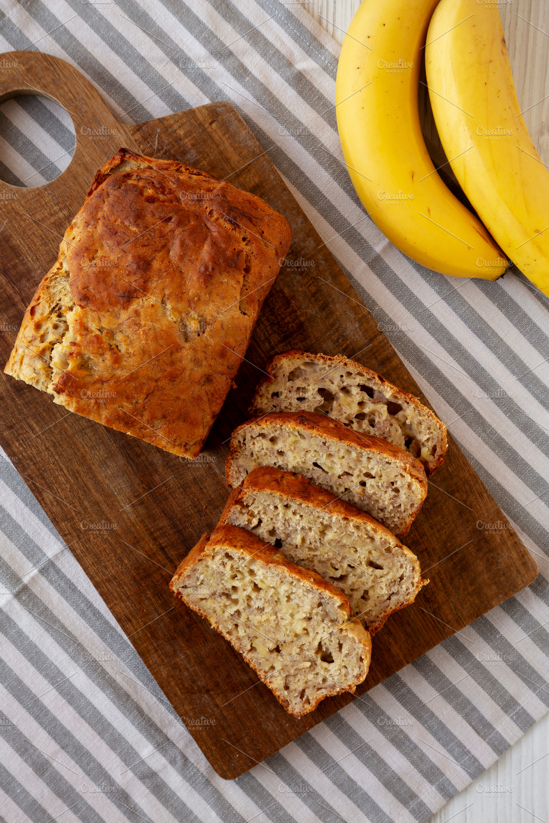 Homemade Banana Bread on a wooden board, top view., a Food & Drink Photo by LiudmylaChuhunova