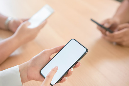 Group of friends holding smartphone