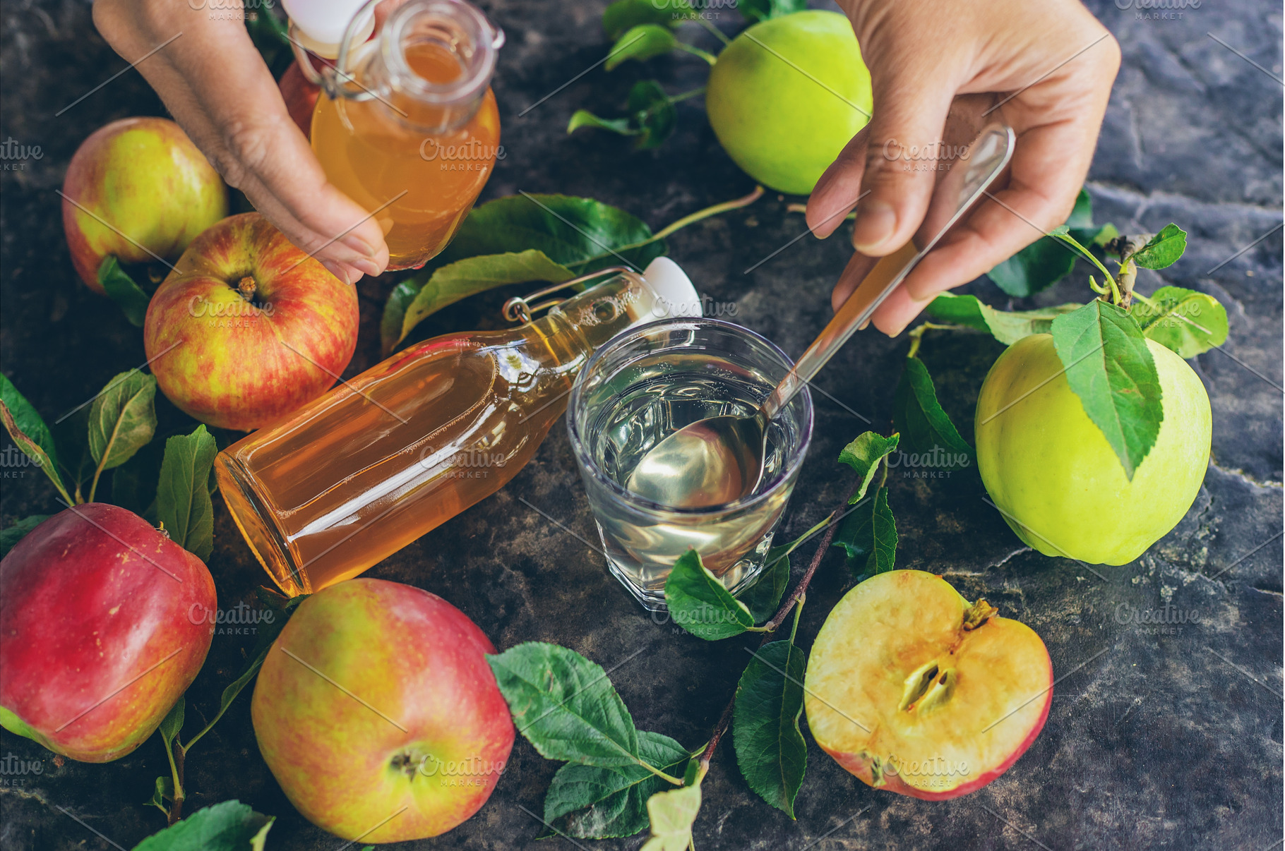 Apple cider vinegar against a, a Food & Drink Photo by yanadjana