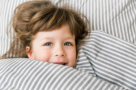 happy child girl in bed, a Person Photo by Kolomiyets Viktoriya