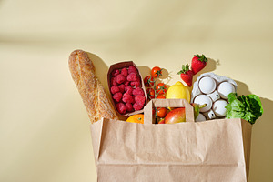 Full paper grocery bag with healthy products. Organic food conce, a Food & Drink Photo by Asya Nurullina