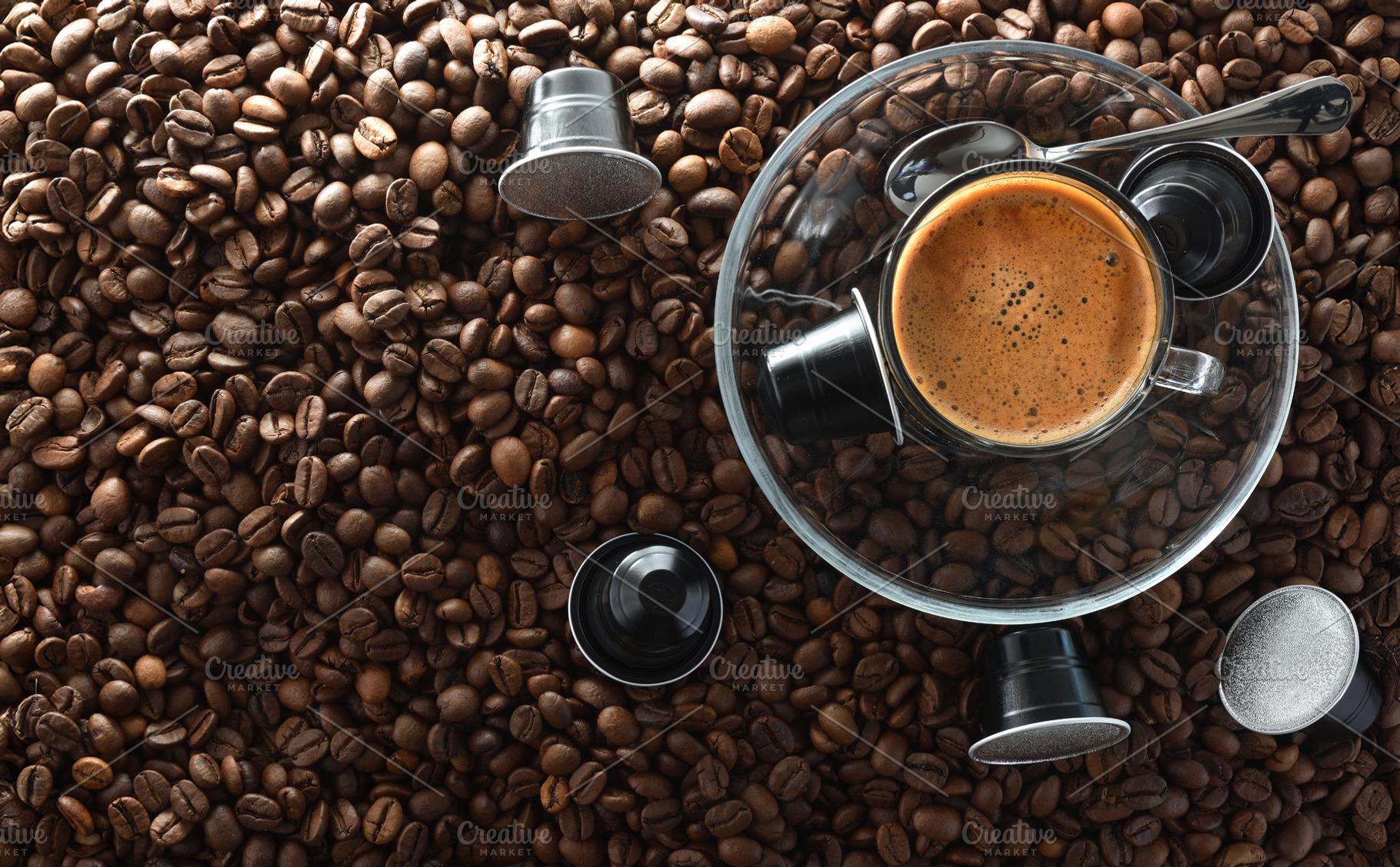 Coffee on glass plate in center on beans and capsules, a Food & Drink Photo by Davizro's Market