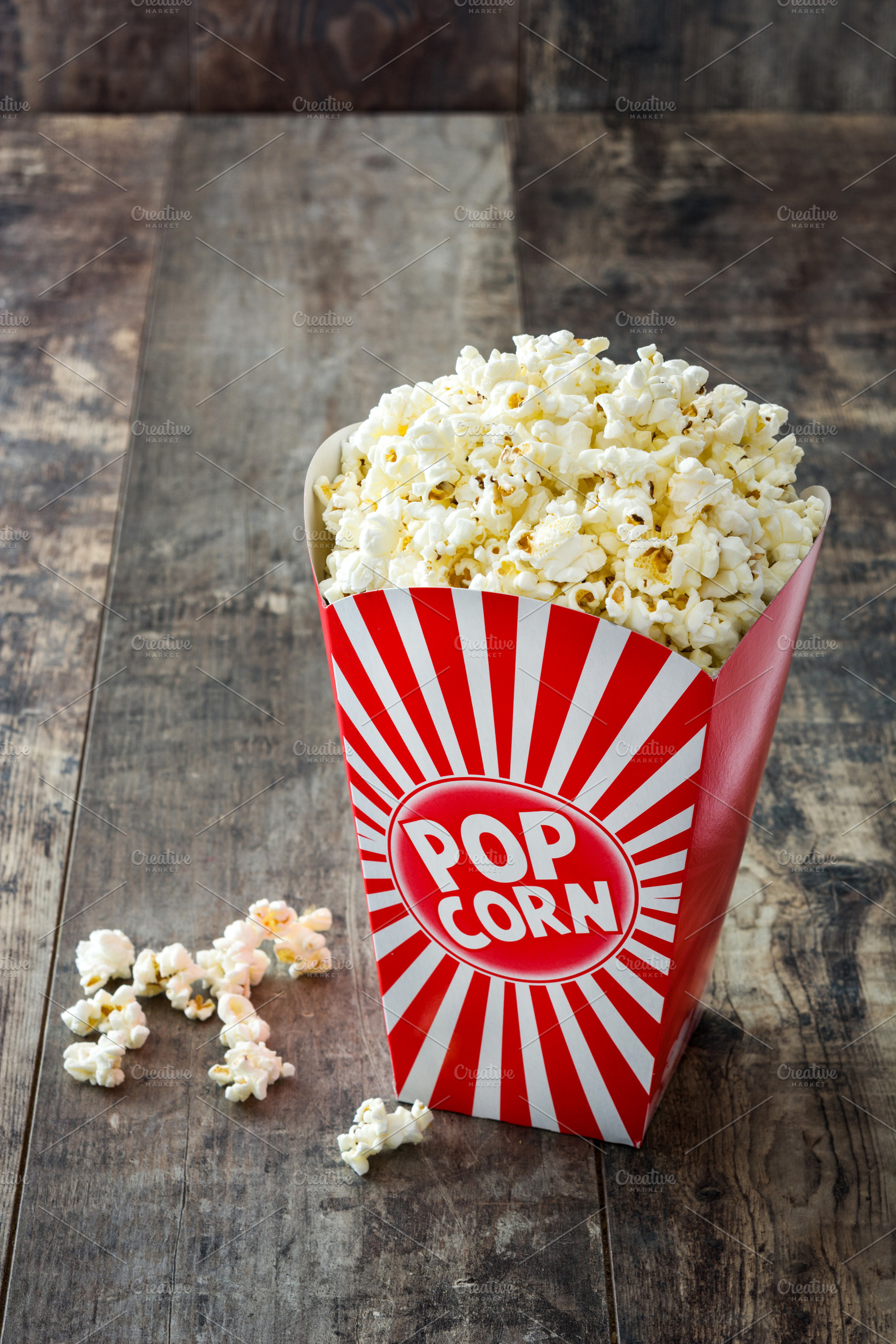Striped box with popcorn containing popcorn, food, and cinema, a Food & Drink Photo by etorres69